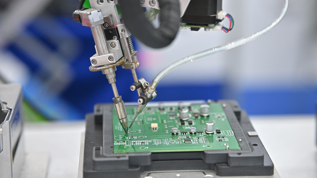 Robotic soldering machine assembling PCB for advanced electronics in robotics, EVs, and smart systems