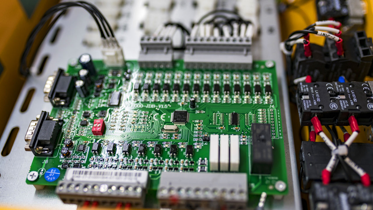 Rugged PCB integrated into control panel with relays and terminal blocks for agricultural and off-highway electronics